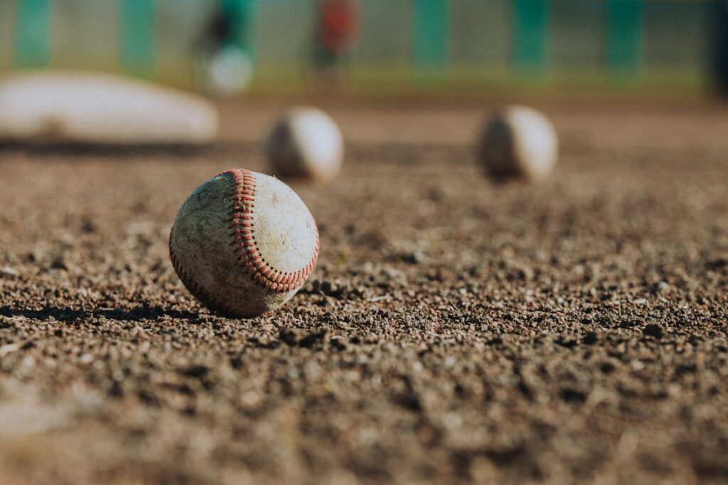 selective focus photography of white baseball balls on ground